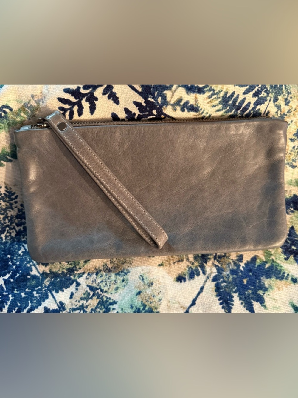 Rough & Tumble Clutch in Storm. Zinc-laquered linen with older style blue label